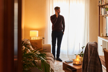 Man talking on his phone in his living room