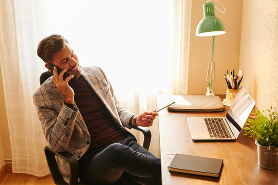 Businessman smiling and talking on the phone