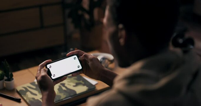 Content Creator content creator, is captured in the photo, holding a cellphone with white screens, signifying his involvement in creating engaging digital content.