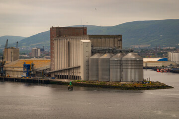 Obraz premium Belfast, Northern Ireland, UK. 7 June 2023. Silos and storage buildings on the River Lagan, Port of Belfast