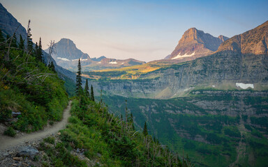 Morning hike viewing mountain peaks and pine forest along Highline Trail | Glacier National Park,...