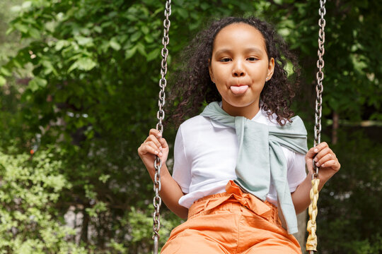 Cute naughty girl on swing set