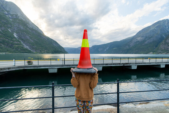 Woman with traffic cone on her head 