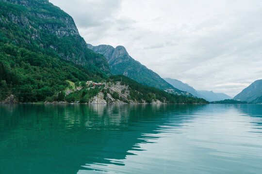 Pristine turquoise lake in Norway surrounded by mountains 