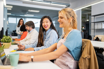 Happy casual people working in a creative coworking