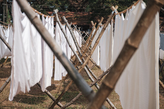 Rows of drying bed sheets.