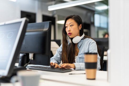 Focused asian woman Working In A Modern Office