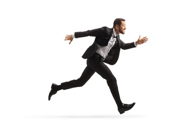 Full length profile shot of a businessman running fast