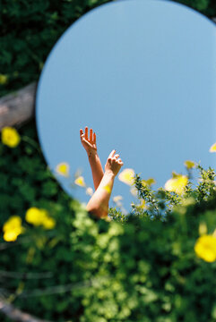 Conceptual photo Of A Woman With A Mirror In the field