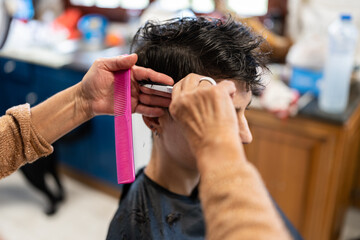 woman cutting another woman's hair at home