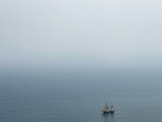 Fototapeta premium Beautiful tall ship sailing deep blue waters toward adventure along Jurassic coast in Dorset, England, UK