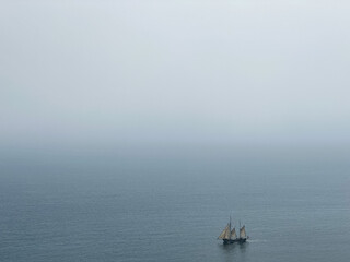 Beautiful tall ship sailing deep blue waters toward adventure along Jurassic coast in Dorset, England, UK
