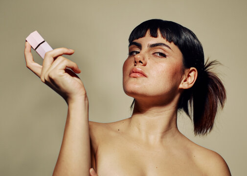 Woman mid blinking, weird expression make up portrait