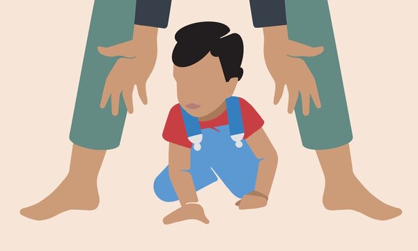 Parent guiding child's first steps in milestone moment of growth