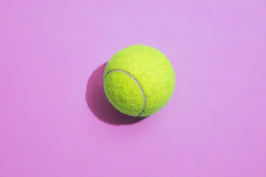 Tennis ball on a colorful background with hard lighting