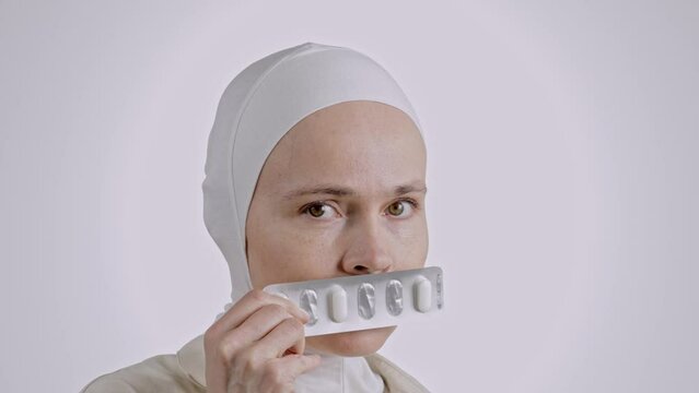 Serious muslim female with vaginal pills and suppository applicator