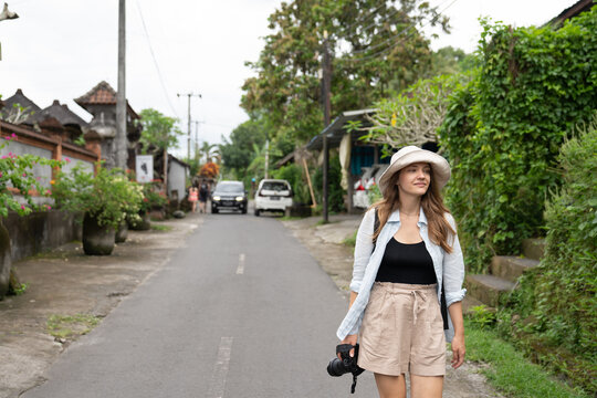 Tourist Walking On The Street In Bali