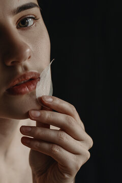 Close Up woman's portrait with leaflet in the hand