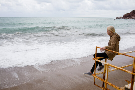 Thinking girl by the winter sea