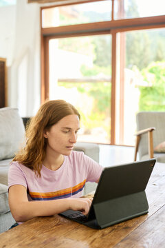 Girl using pad at table.