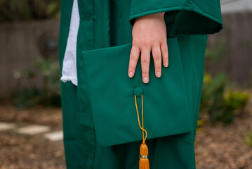 Student hand holding graduation cap