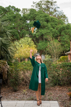 Student tossing graduation cap