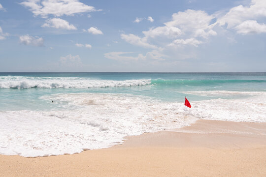 Red Flag In The Water At Dreamland Beach In Bali