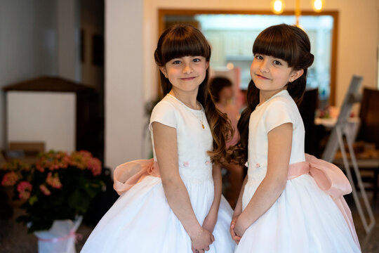 Twins dressed in communion gowns