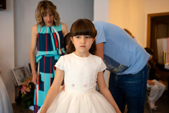 Parents helping  daughter to dress up