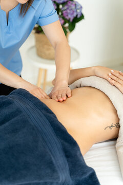 Woman in the spa receiving a reductive massage.