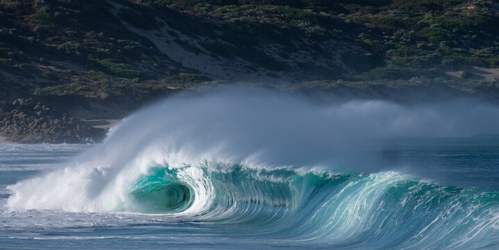 A Powerful beautiful wave breaking from a side view