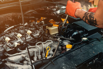 An auto mechanic repairs a car with a socket wrench. Close-up. Quality professional car repair. Content for advertising