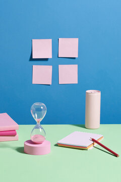 hourglass with book on the color background