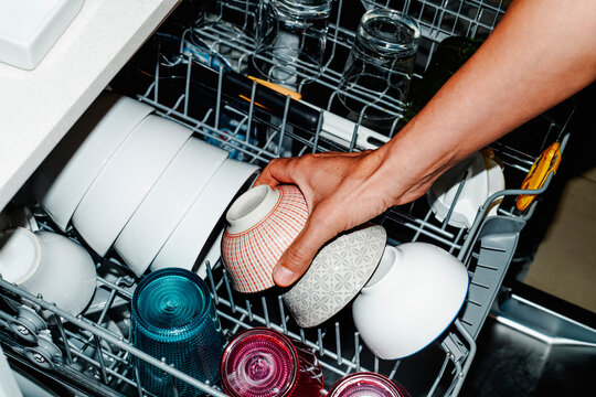 man putting a bowl in the dishwasher