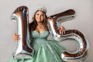 Teenager Dressed in Quinceanera Gown Shot in Studio With "15" Ba