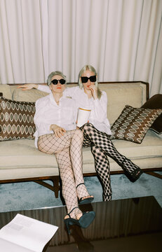 Couple with pop corn and sunglasses indoors