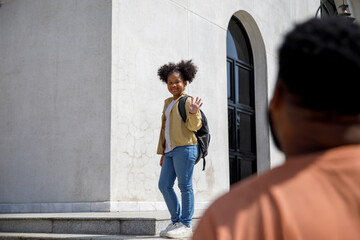 Daughter waving goodbye to dad