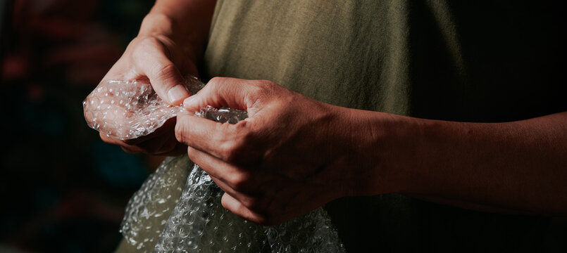 popping the bubbles of a bubble wrap, banner format