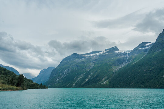 Pristine turquoise lake in Norway surrounded by mountains 