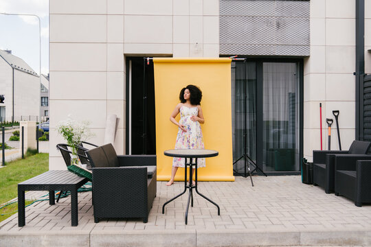 Photoshoot Of Pregnant Woman In Yellow Background