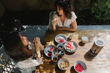 Women in the garden having a breakfast