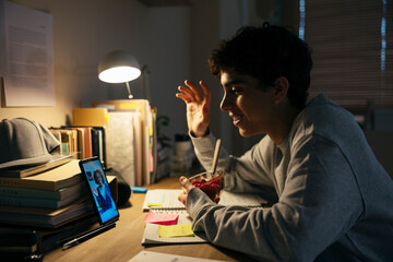 Teenage male studying late night at home