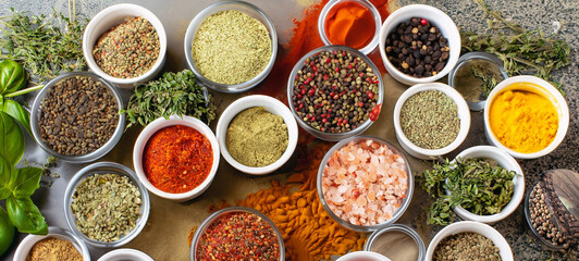 Fresh spices and herbs for food. Colorful condiments as background, top view. lot seasonings in cups, on table