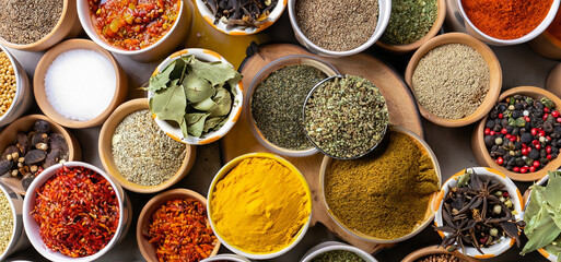 Fresh spices and herbs for food. Colorful condiments as background, top view. lot seasonings in cups, on table