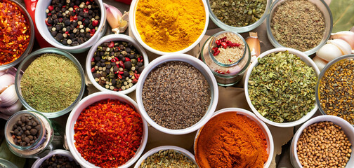 Fresh spices and herbs for food. Colorful condiments as background, top view. lot seasonings in...