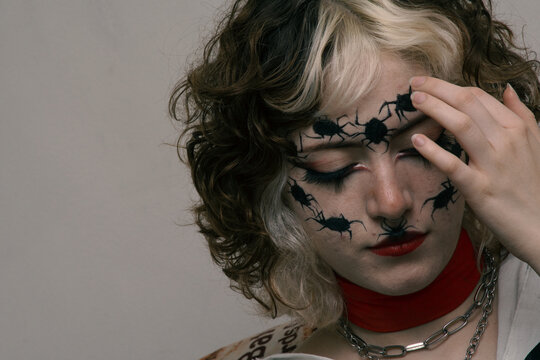 Portrait of a young woman with a make up of spiders in her face