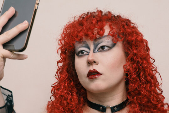 Portrait of a young goth woman taking a selfie