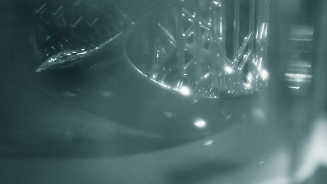 Working of photopolymer sla 3D printer. Platform with building object lowered into liquid photopolymer resins and hardened under ultraviolet laser. Progressive additive technology. 3D printer printing