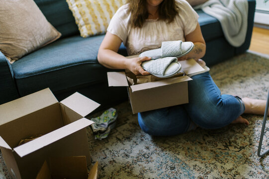 online shopper unboxing her purchase at home
