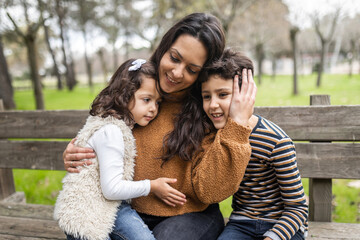 mother with her children outdoors in nature